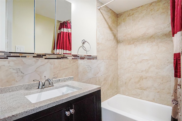 full bathroom featuring tile walls, shower / bathtub combination with curtain, and vanity