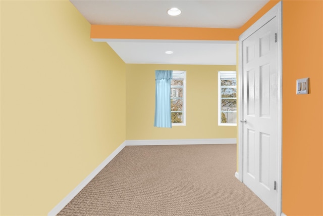 hallway with carpet floors, baseboards, and recessed lighting