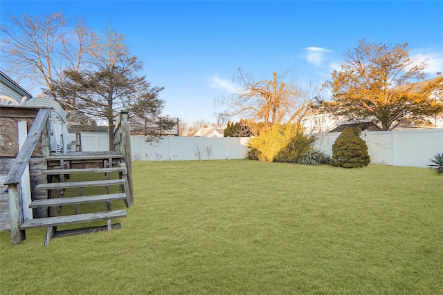 view of yard featuring stairway and a fenced backyard