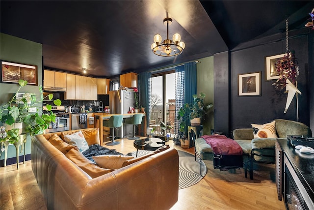 living room featuring light wood-type flooring and a notable chandelier