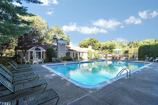 pool featuring a patio and fence