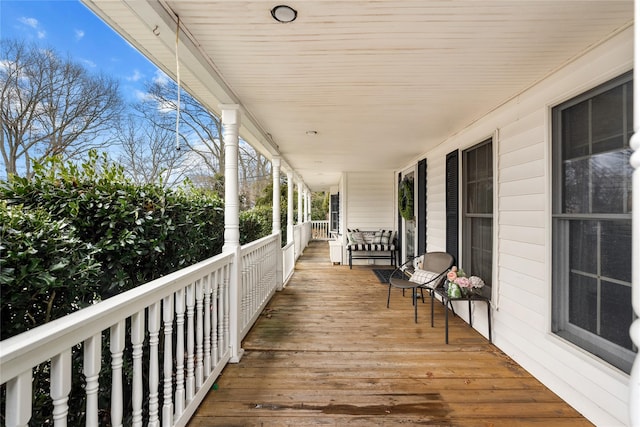 wooden terrace featuring covered porch