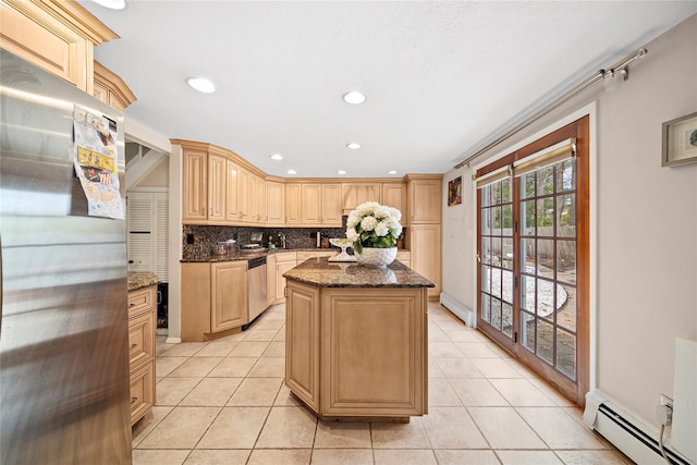 kitchen featuring light tile patterned floors, a kitchen island, a baseboard radiator, appliances with stainless steel finishes, and a baseboard heating unit