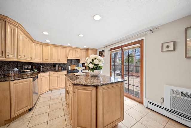 kitchen featuring tasteful backsplash, a kitchen island, custom range hood, baseboard heating, and stainless steel dishwasher