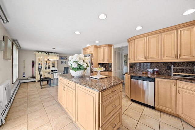 kitchen featuring light tile patterned floors, decorative backsplash, a kitchen island, and stainless steel appliances