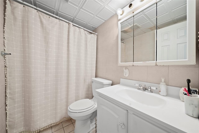 full bathroom featuring tile patterned flooring, toilet, vanity, an ornate ceiling, and tile walls