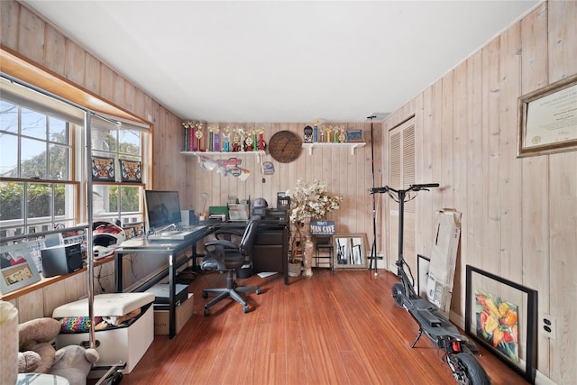 home office featuring wood walls and wood finished floors