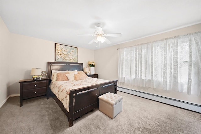 bedroom with a ceiling fan, baseboards, carpet floors, and a baseboard radiator