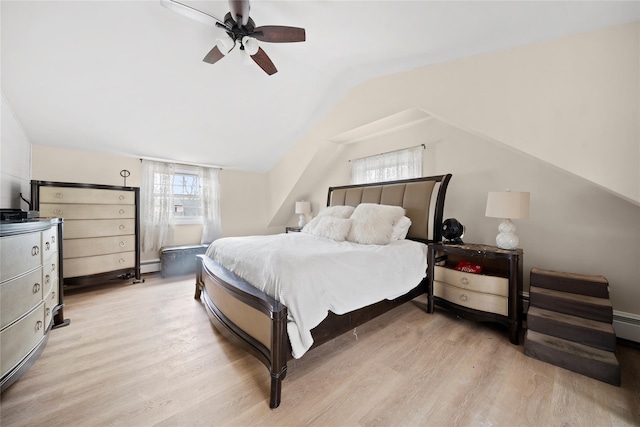 bedroom featuring vaulted ceiling, light wood-style flooring, baseboard heating, and ceiling fan