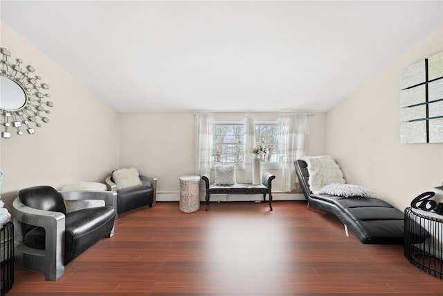 living area featuring baseboard heating, wood finished floors, and vaulted ceiling