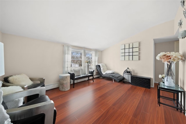 living area featuring vaulted ceiling, baseboard heating, baseboards, and wood finished floors