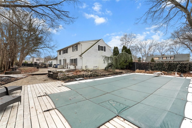 view of swimming pool featuring a patio and fence