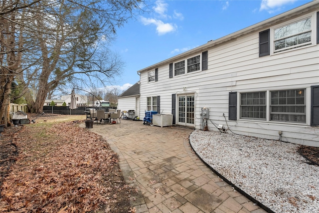 rear view of property featuring a patio and fence