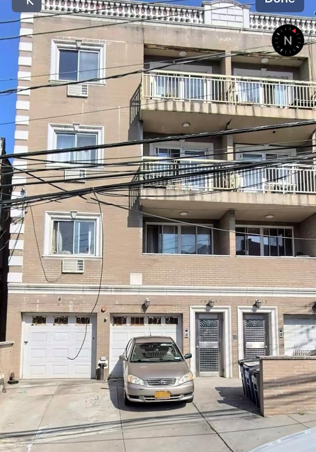 view of building exterior with driveway and an attached garage