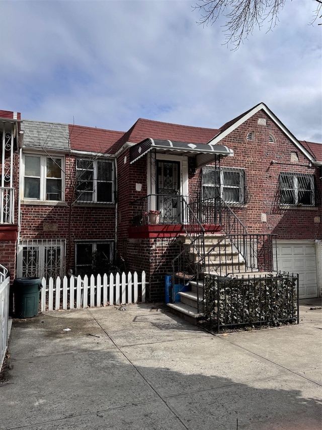 view of front facade with a fenced front yard and brick siding