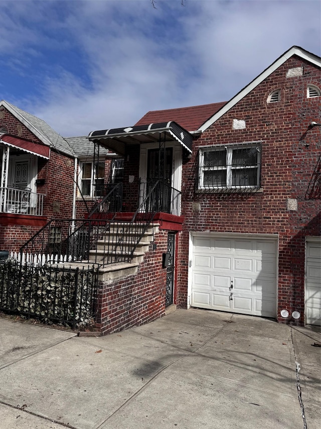 view of front facade with brick siding, driveway, and an attached garage