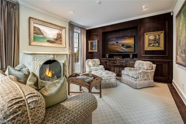 sitting room featuring ornamental molding, a fireplace, wood finished floors, and baseboards