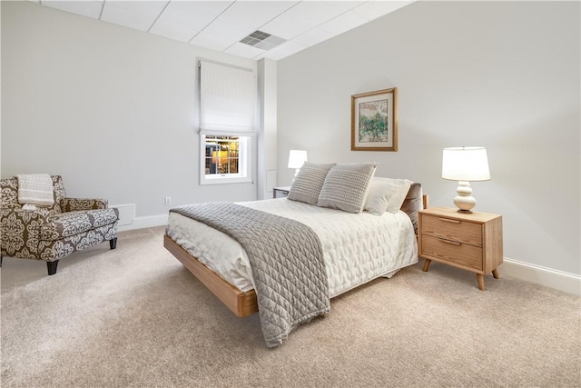 bedroom featuring baseboards, visible vents, and light colored carpet