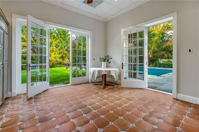 entryway featuring french doors, crown molding, baseboards, and ceiling fan