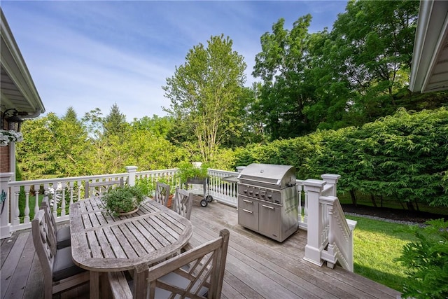 wooden deck with grilling area and outdoor dining space