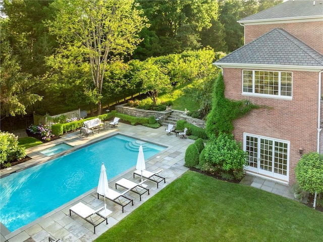 view of swimming pool with a fenced in pool, a patio, fence, and a lawn