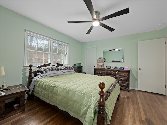 bedroom featuring ceiling fan, baseboards, and dark wood-style flooring