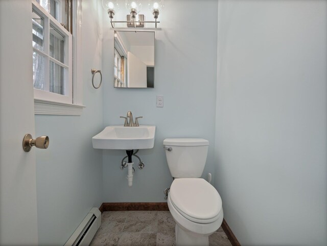 bathroom featuring an inviting chandelier, toilet, baseboards, and a baseboard radiator