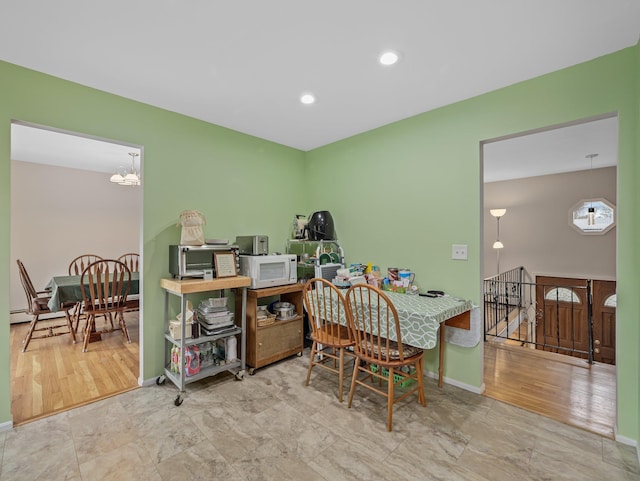 dining area featuring recessed lighting, baseboards, and a chandelier