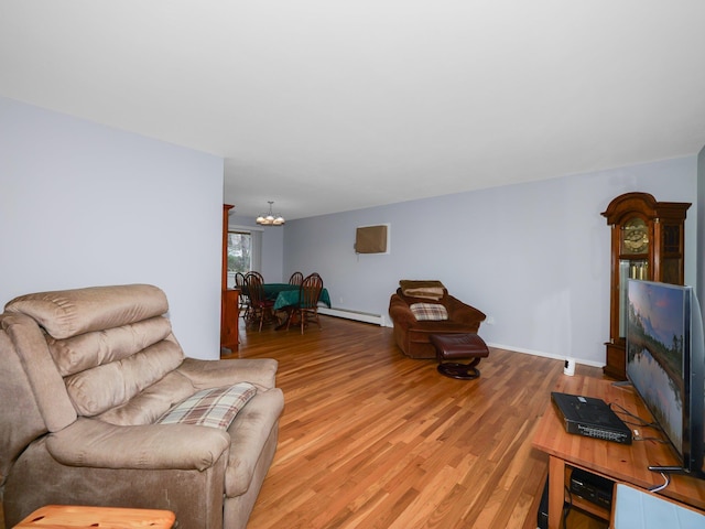 living room featuring a baseboard heating unit, light wood-type flooring, and a chandelier