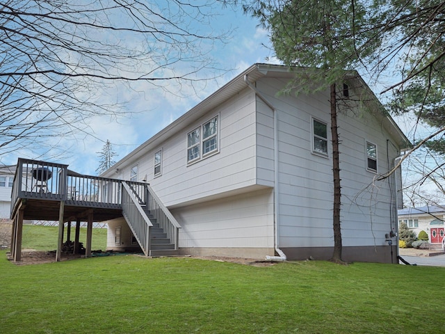 view of side of home featuring a wooden deck, stairs, and a yard