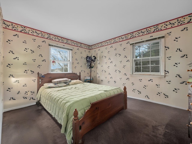 bedroom featuring baseboards and dark colored carpet