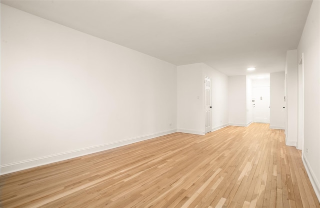 spare room with light wood-style flooring and baseboards