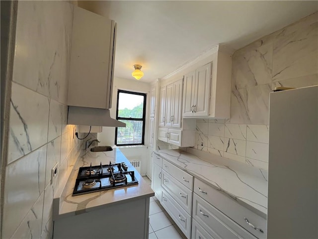 142 Garth Rd Unit 1P, Scarsdale, NY 10583 - kitchen featuring gas stovetop, extractor fan, backsplash, and light stone counters