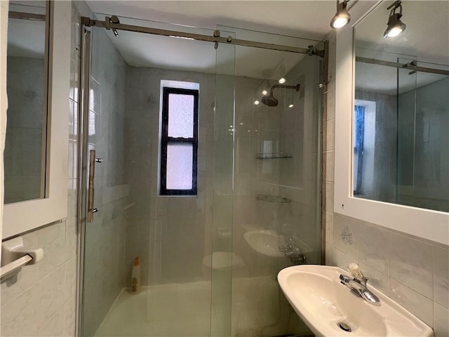 142 Garth Rd Unit 1P, Scarsdale, NY 10583 - bathroom with tile walls, a shower stall, and a sink