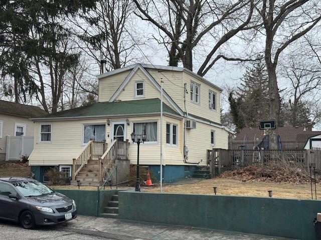 view of front of house featuring an AC wall unit