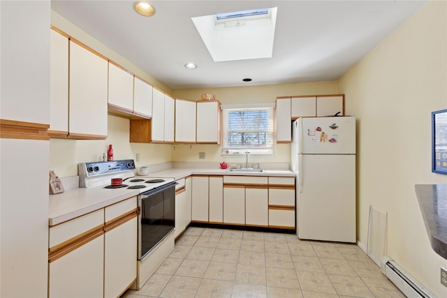 kitchen with light countertops, baseboard heating, a skylight, white appliances, and a sink