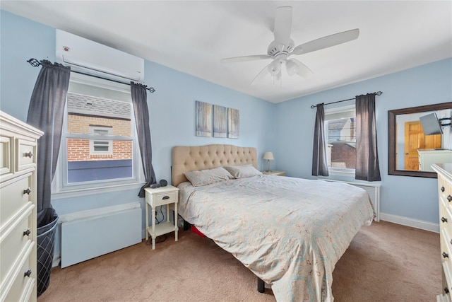 bedroom featuring baseboards, a wall unit AC, a ceiling fan, and light colored carpet