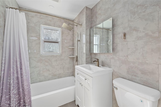 full bathroom featuring toilet, tile walls, shower / bath combination with curtain, and vanity