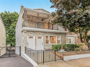 view of front of property featuring a fenced front yard and a balcony