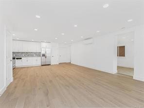 unfurnished living room with light wood-type flooring