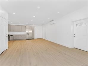 unfurnished living room featuring light wood-style flooring