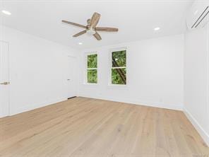 spare room featuring recessed lighting, ceiling fan, wood finished floors, and a wall mounted air conditioner