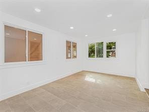 empty room with recessed lighting and baseboards