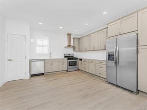 kitchen featuring light wood-type flooring, wall chimney exhaust hood, appliances with stainless steel finishes, and recessed lighting