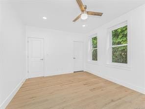 empty room with ceiling fan, light wood-type flooring, and recessed lighting