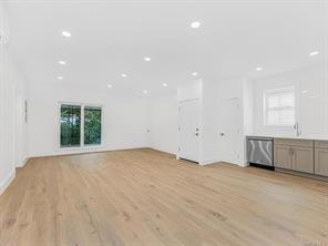 unfurnished living room with light wood-type flooring and recessed lighting