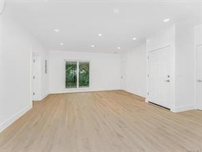 unfurnished living room featuring light wood-type flooring and recessed lighting