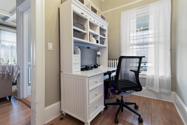 office with plenty of natural light, baseboards, and wood-type flooring