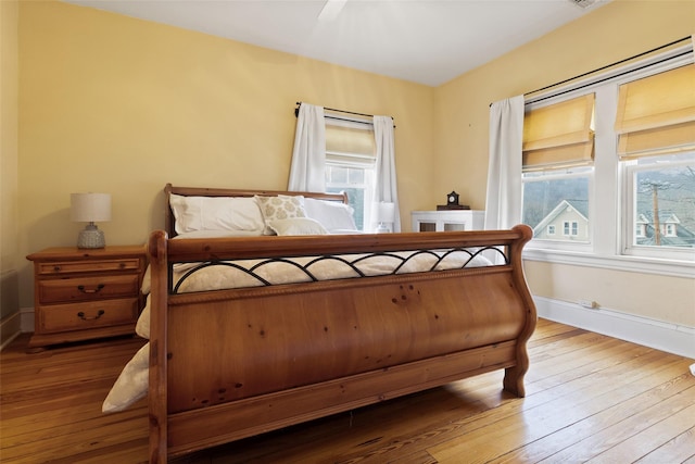 bedroom with baseboards and wood-type flooring