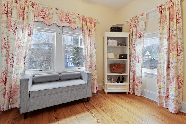 living area featuring baseboards and wood finished floors